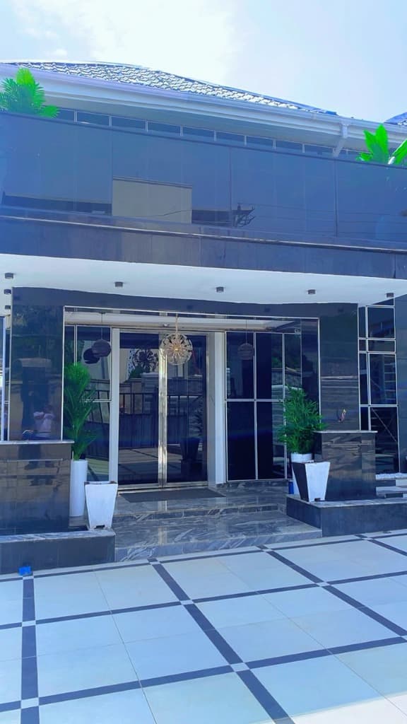 Super E Luxury Hotel 24/7 Grand Entrance, Ambient Chandelier and Black Marble Tinted Glass Facade in Keffi Nasarawa State